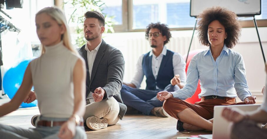 Office workers meditating at work