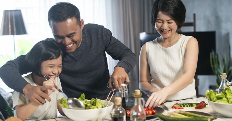 asian family preparing healthy food in the kitchen