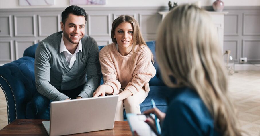 Real-estate agent shows a build project to a young couple.