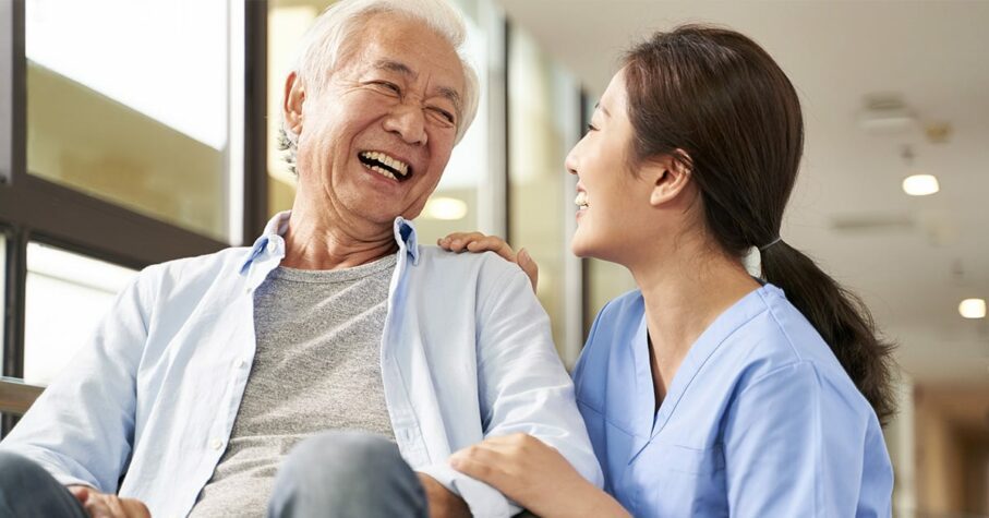 nurse taking care of asian elderly man on a wheelchain