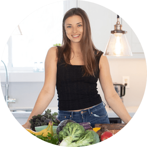 Natalie Pierzchalski standing with vegetable and fruits on the table