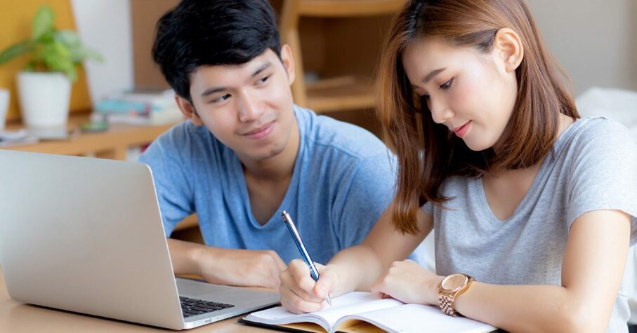 Beautiful young asian couple calculate expenses finance with laptop and planning together, woman writing notebook or note budget household, lifestyle family and business