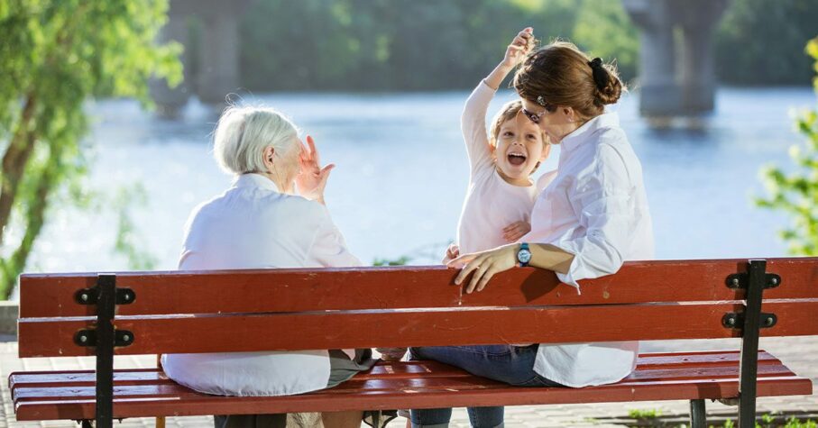 Senior woman, her adult granddaughter and great grandson in park