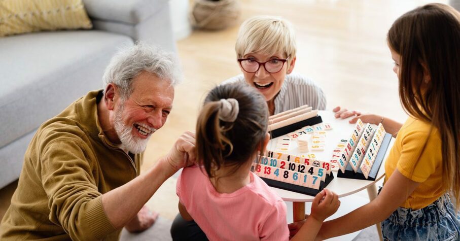 Grand daughters playing with their grandparents at home