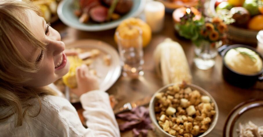 Girl enjoying Thanksgiving dinner.