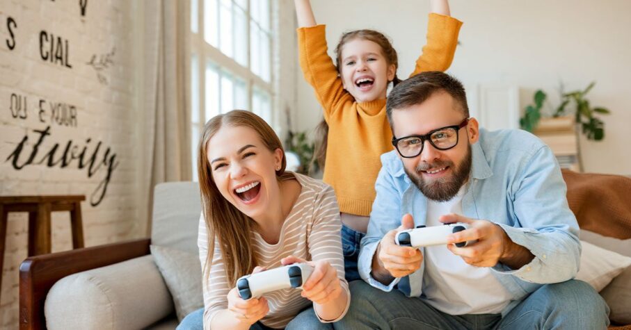 Girl supporting parents playing videogame