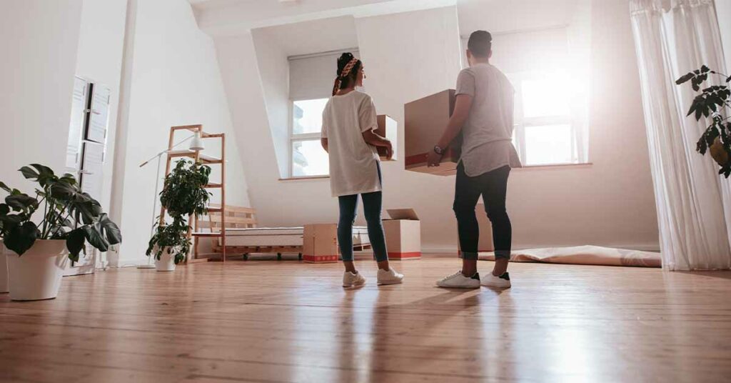 A young couple moving into their new home