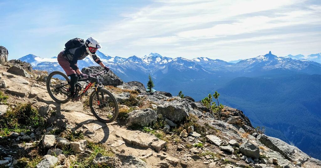 Person mountain biking on a mountain range