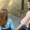 Mother in a wheelchair holding the hand of her daughter in the park