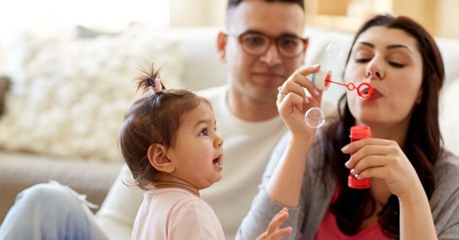 Young family playing with their toddler